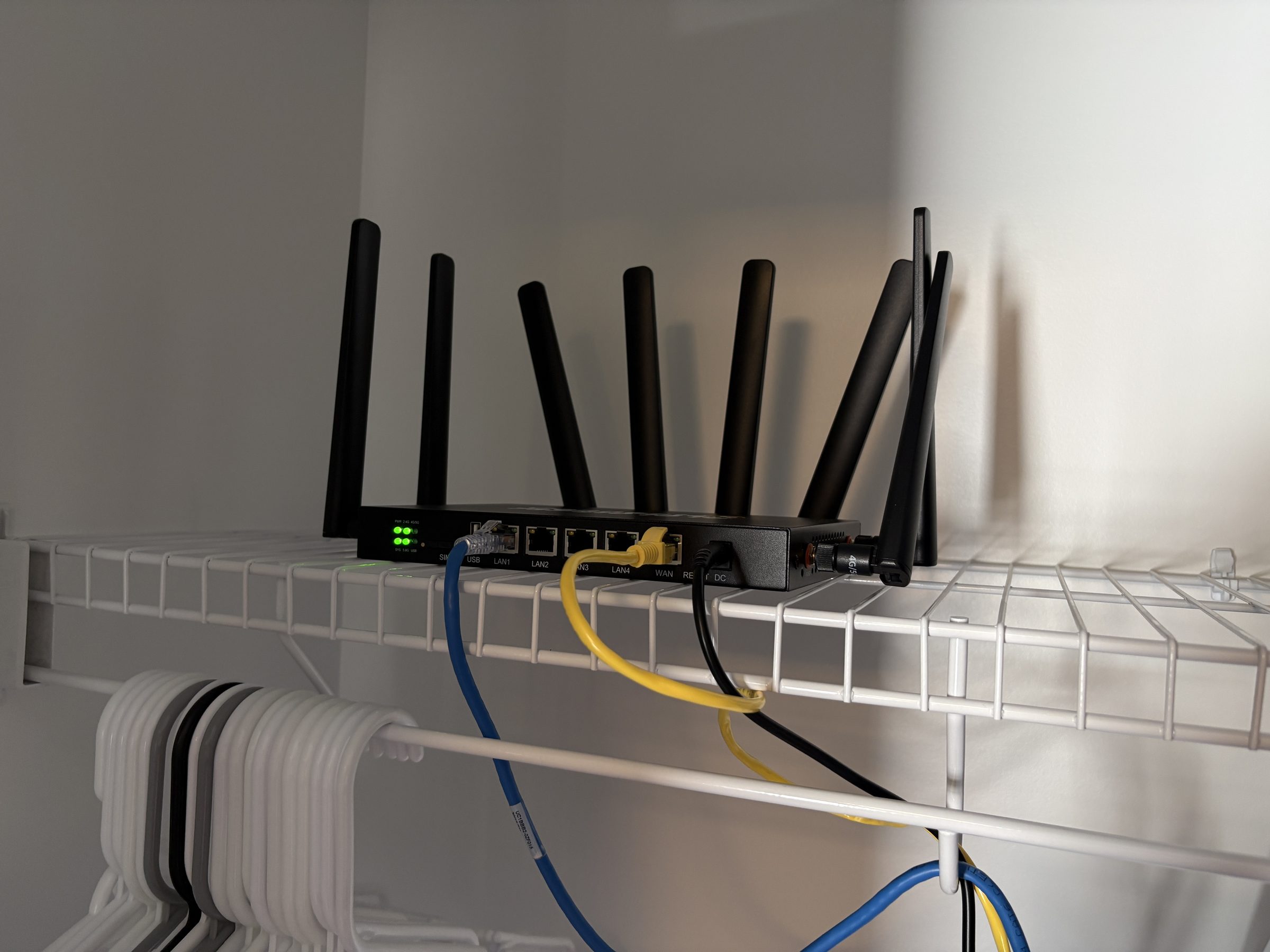 Connecten router mounted on a wire network shelf with ethernet cables, failover infrastructure setup